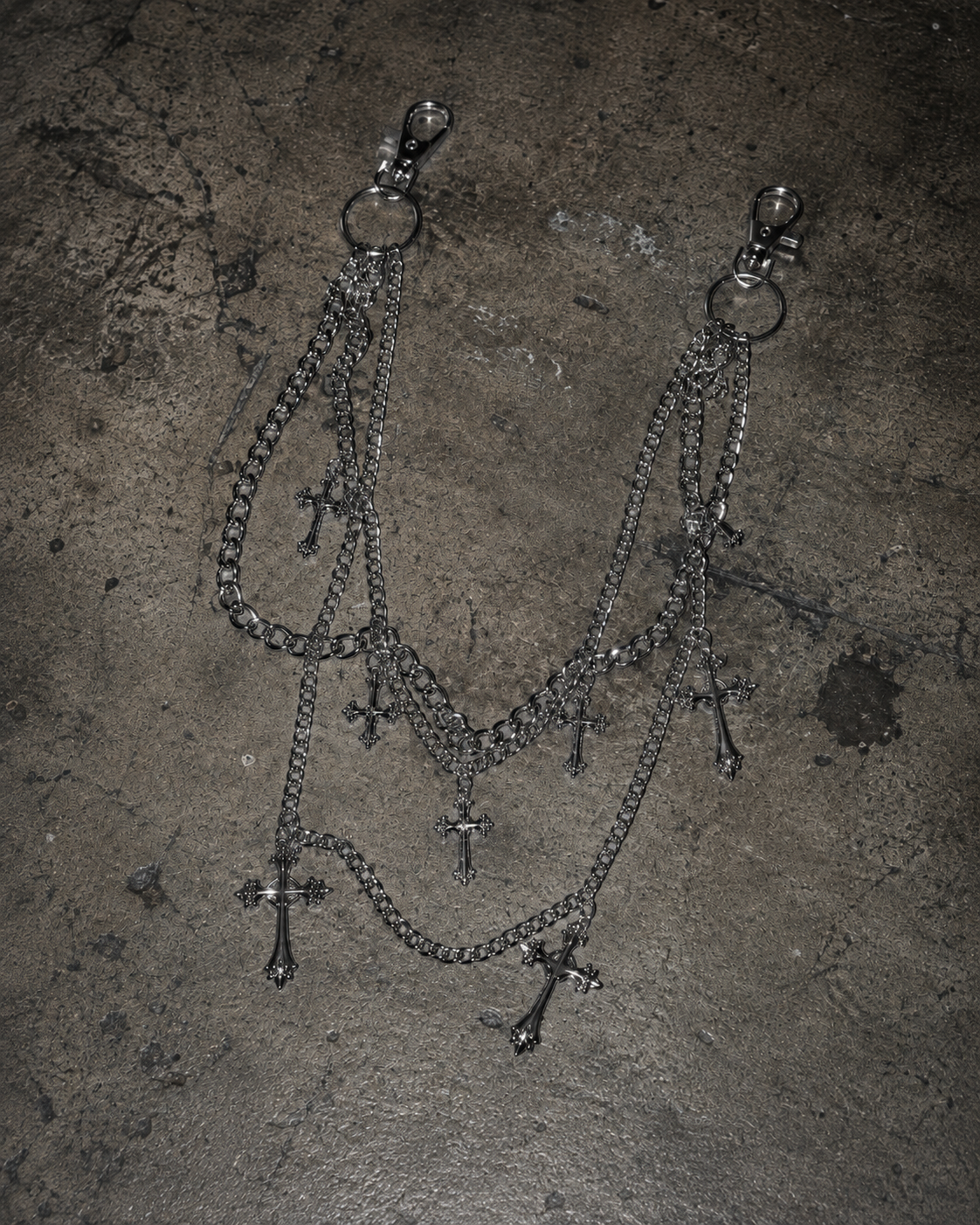 ADRN 01 Cross silver-tone pants chain photographed on a raw concrete surface