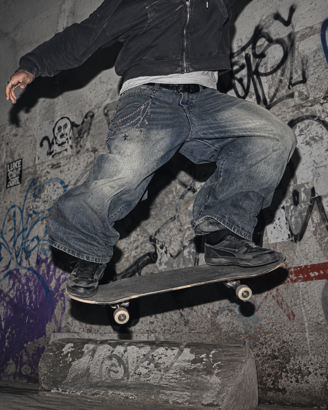 ADRN 01 Cross silver-tone pants chain styled with oversized washed denim during a skate campaign shot