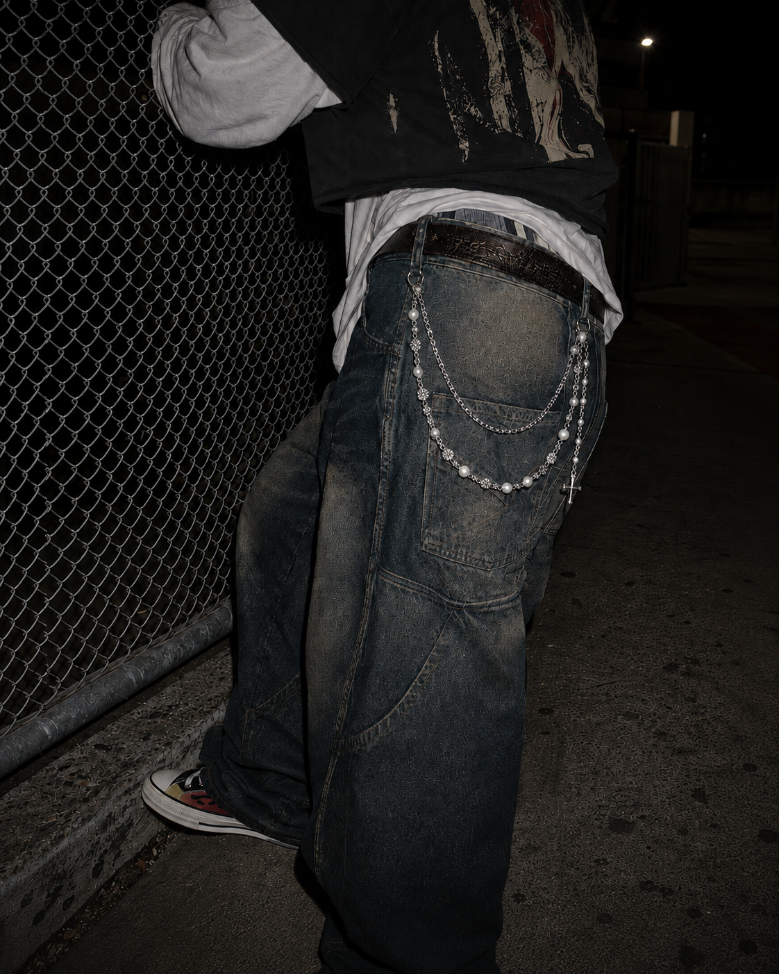 ADRN 03 Flower Silver pants chain shown from a rear three-quarter angle on oversized washed denim