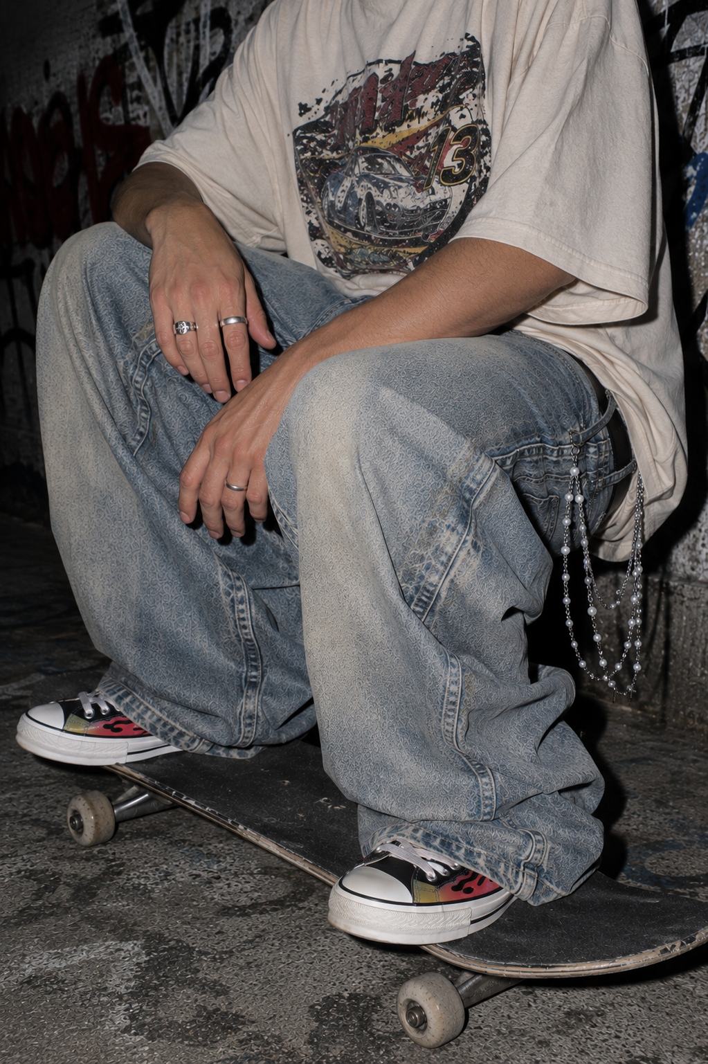 ADRN 03 Flower Silver pants chain styled with oversized washed denim in a crouched skate campaign shot